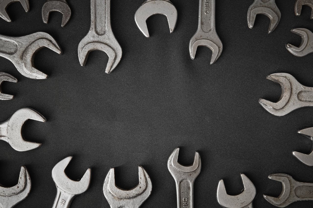 Assorted spanners laid out in a circular pattern with copy space.
